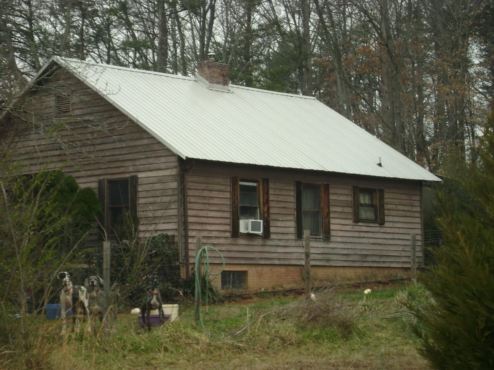 White metal roof on an old wood sided farmhouse, from a Metal Roof Installation job in Murray